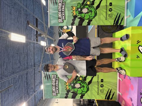 Two players on the podium at the indoor Orlando Advanced Pickleball facility